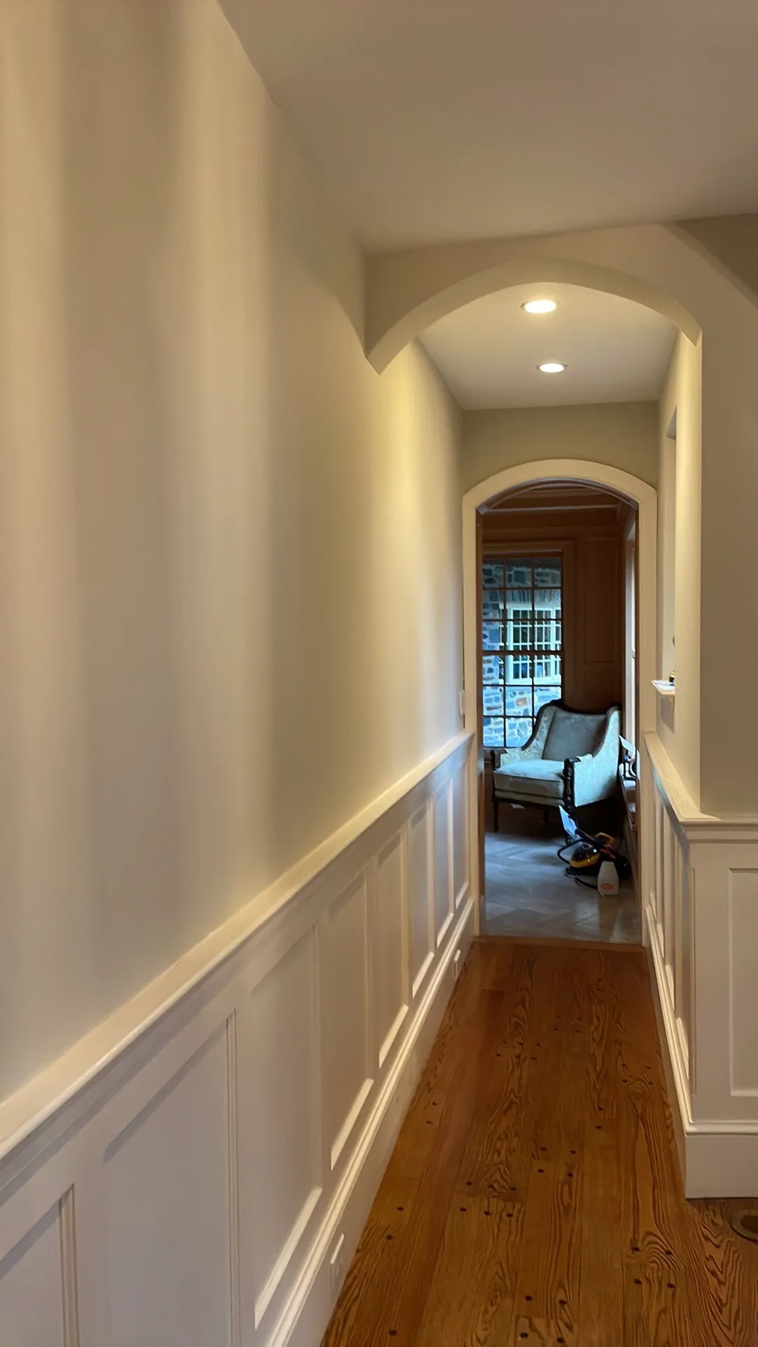 Hallway with painted wainscoting and cream walls