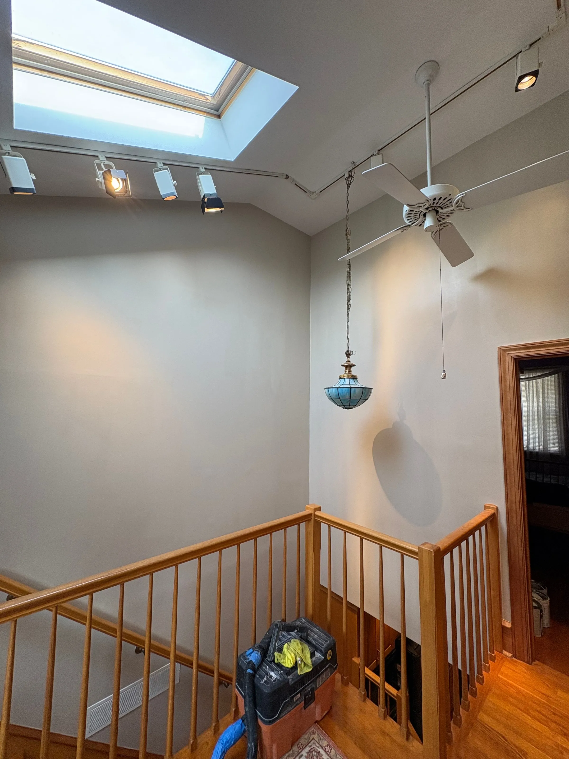 Stairwell with skylight, freshly painted white walls and ceiling