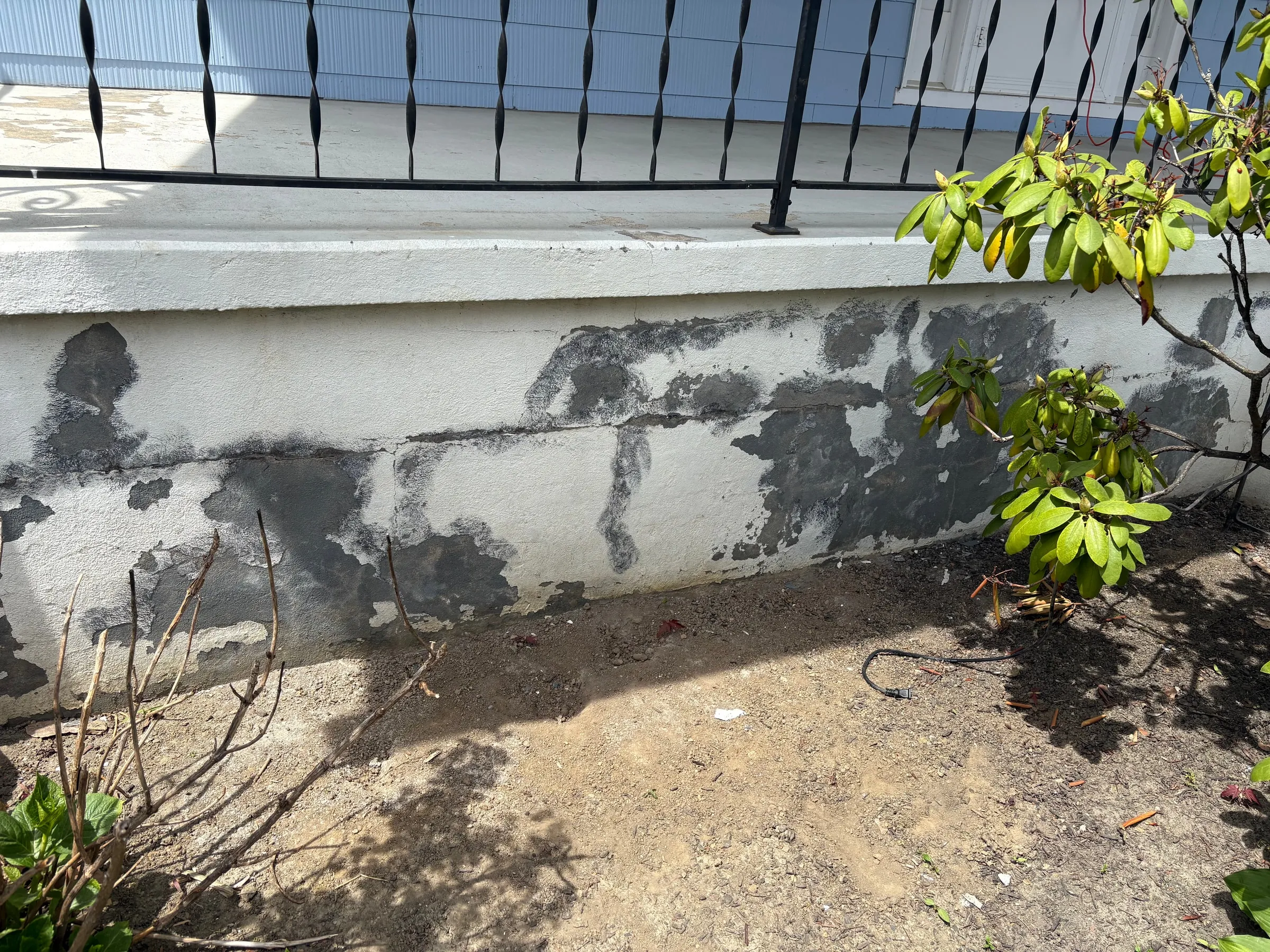 Exterior foundation and stucco surface prepared before coating